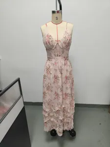 Detailed view of a floral print spaghetti strap maxi dress with elegant ruffled hemline