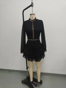 Detail of elegant black chiffon long-sleeved dress with hollow-out lace and ruffled hem