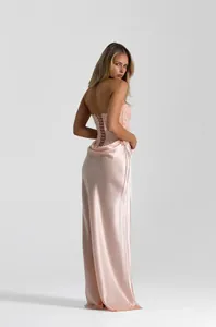 Back view of elegant light pink sequined corset gown with satin fishtail skirt.