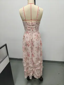 Back view of pink floral maxi dress featuring lace-up detail and elegant ruffled hem