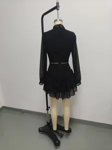 Rear view of elegant black hollow-out chiffon dress with ruffled hem and sheer long sleeves
