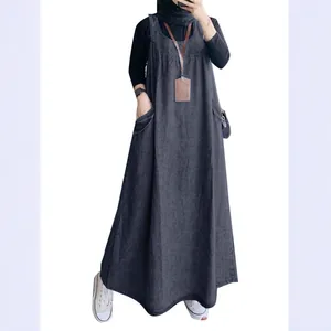 Full-length view of a retro loose denim pinafore dress with large side pockets