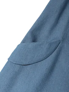 Close-up detail showing the curved side pocket and fabric texture of the blue denim dress.