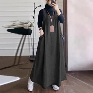 Detail view of charcoal grey maxi denim pinafore dress with functional side pockets