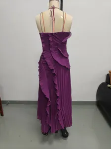 Back view detail of a purple pleated halter dress with ruffled tiers and backless design