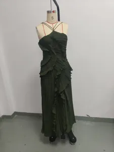 Close-up detail of a dark green pleated halter neck backless maxi dress on mannequin