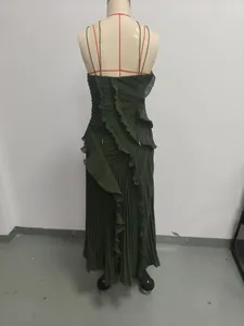 Back view of elegant pleated dark green maxi dress showing ruffle details on a mannequin.