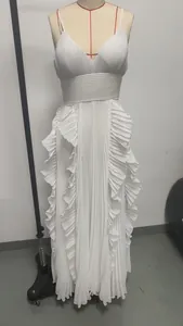 Full-length white pleated maxi dress with elegant ruffle detailing on a mannequin