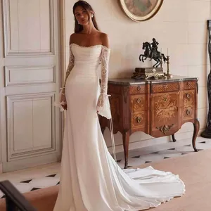 Elegant off-the-shoulder mermaid wedding dress with delicate lace sleeves and a train.