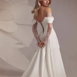 Elegant off-shoulder wedding gown featuring lace sleeves and a corset-style back detail