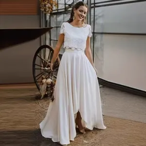 Close-up of a bohemian bridal wedding dress featuring delicate lace and a satin skirt
