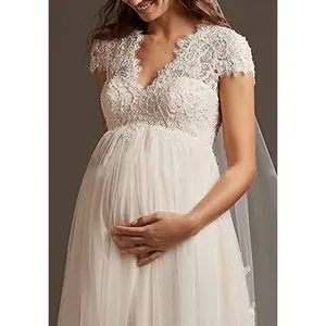 Detail of maternity wedding dress with delicate lace bodice and high waist design