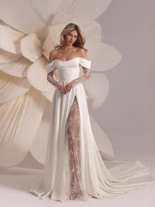 Elegant off-the-shoulder white wedding dress with lace sleeves and high slit details