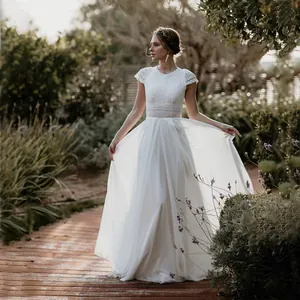 Elegant minimalist white lace wedding dress for brides in outdoor garden setting