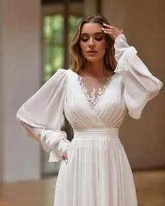 Detail eines eleganten weißen Brautkleides mit V-Ausschnitt, Blumenstickerei und Puffärmeln