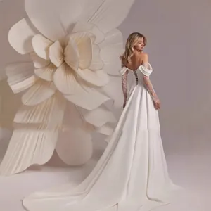 Back view of elegant off-the-shoulder wedding dress with lace sleeves and train