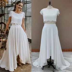 Elegant white two-piece lace wedding dress with a high-low skirt for travel photography.