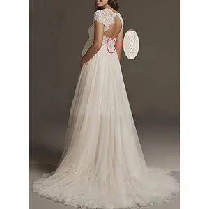 Detailed view of the elegant lace-up back closure on a white maternity wedding dress