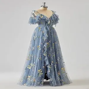 Detailed view of dusty blue evening gown with floral embroidery and ruffled tulle