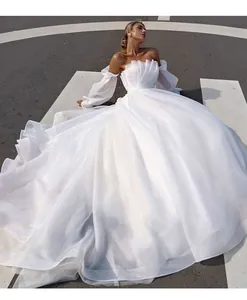 Elegant off-the-shoulder white wedding gown with pleated bodice and puffy sleeves