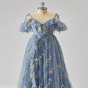 Detailed view of an elegant blue tulle evening gown with intricate floral embroidery