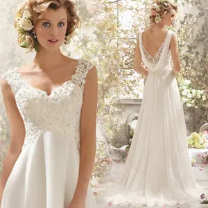 Detailed view of elegant white lace wedding dress with low back and delicate floral embroidery.