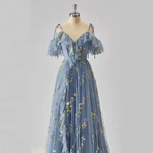 Elegant dusty blue off-the-shoulder evening gown with colorful floral embroidery and ruffles