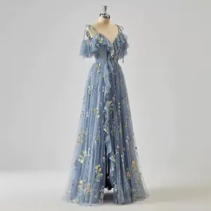 Elegant dusty blue spaghetti strap evening gown with colorful floral embroidery and ruffles.