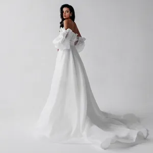 Elegant off-the-shoulder French style white wedding dress with puff sleeves and long train