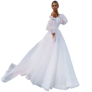 Elegant white off-the-shoulder wedding dress with puffy sleeves and voluminous skirt