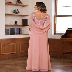 Detail of the elegant lace applique on the back of the pink chiffon evening dress.