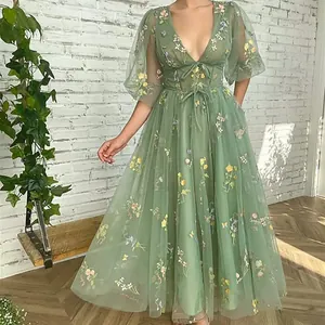 Detailed view of exquisite sage green floral embroidery on a V-neck tulle evening gown