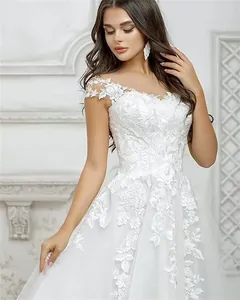 Detail of white bridal wedding dress with elegant floral lace and mesh layers