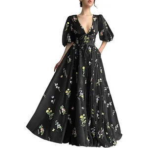 Detailed view of an elegant black V-neck maxi dress with colorful floral embroidery.