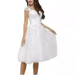 Elegant white mid-length wedding dress with floral lace detailing and tulle skirt