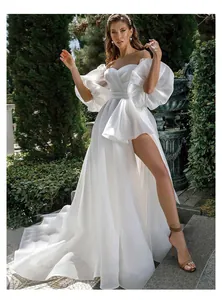 Elegant off-the-shoulder white wedding dress featuring puff sleeves and high leg slit