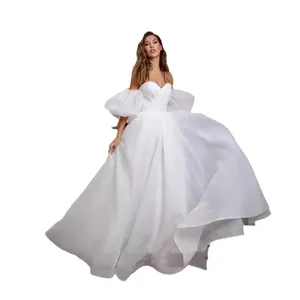 Elegant white off-the-shoulder wedding dress with puff sleeves and sweetheart neckline