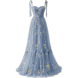 Elegant light blue floor-length evening gown featuring intricate floral embroidery and tied straps