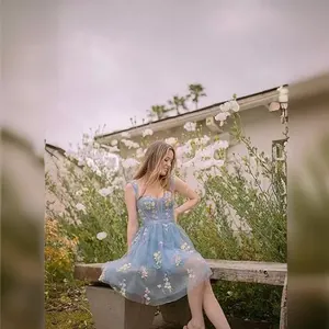 Light blue spaghetti strap evening dress with floral embroidery and lace-up back