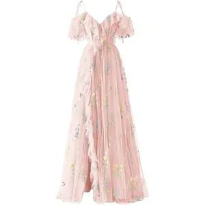 Detail showing floral embroidery and ruffle layers on this elegant pink tulle gown.
