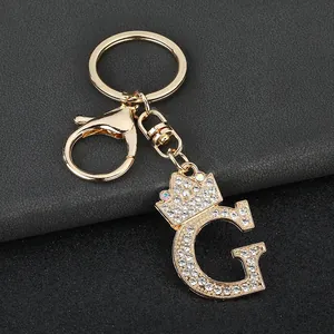Close-up of the sparkling rhinestone initial G keychain with golden crown detail