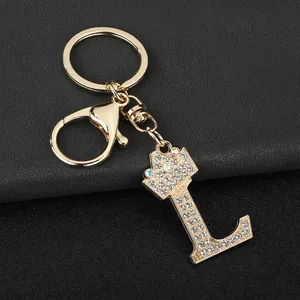 Detailed close-up of sparkling rhinestone letter L keychain with golden crown