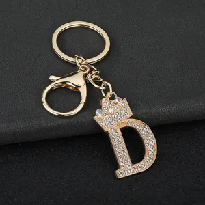 Close-up of a premium gold-tone sparkly letter D keychain with rhinestone crown