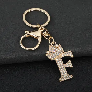 Close-up of gold letter F keychain with sparkling rhinestones and crown detail.