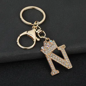Detailed view of gold-tone letter N keychain with crown and sparkling rhinestones