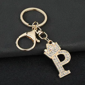 Detailed shot of gold-toned zinc alloy keychain with rhinestone letter P and crown