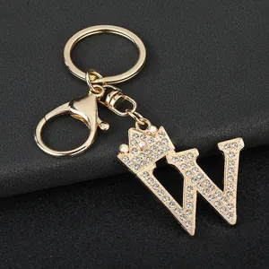 Close-up detail of gold crown letter W keychain with sparkling crystal rhinestones