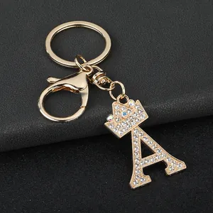 Detailed view of sparkling rhinestone initial A keychain with crown in gold finish