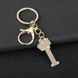 Detailed view of a gold-plated letter I keychain featuring crown and sparkling rhinestones.