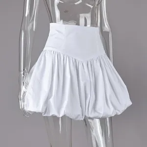 Close-up of white high-waist cotton bubble skirt with pleated puff hem on mannequin.